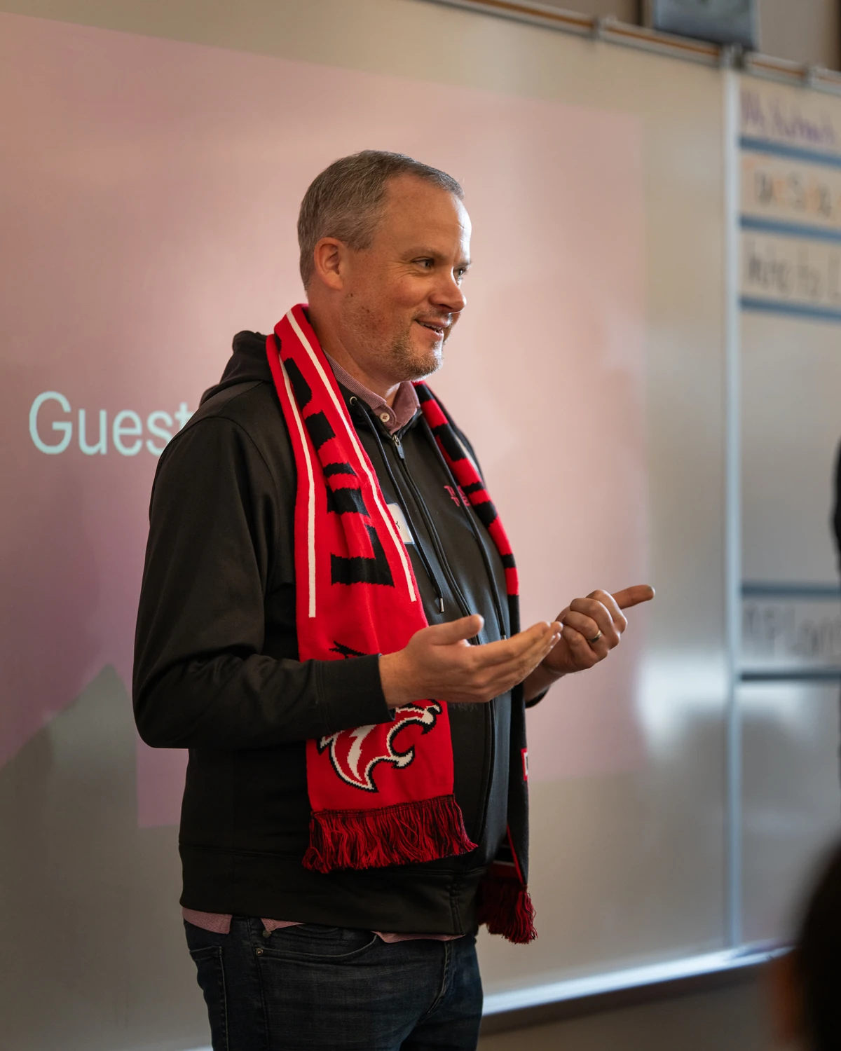 Man speaking to a group, gesturing while talking
