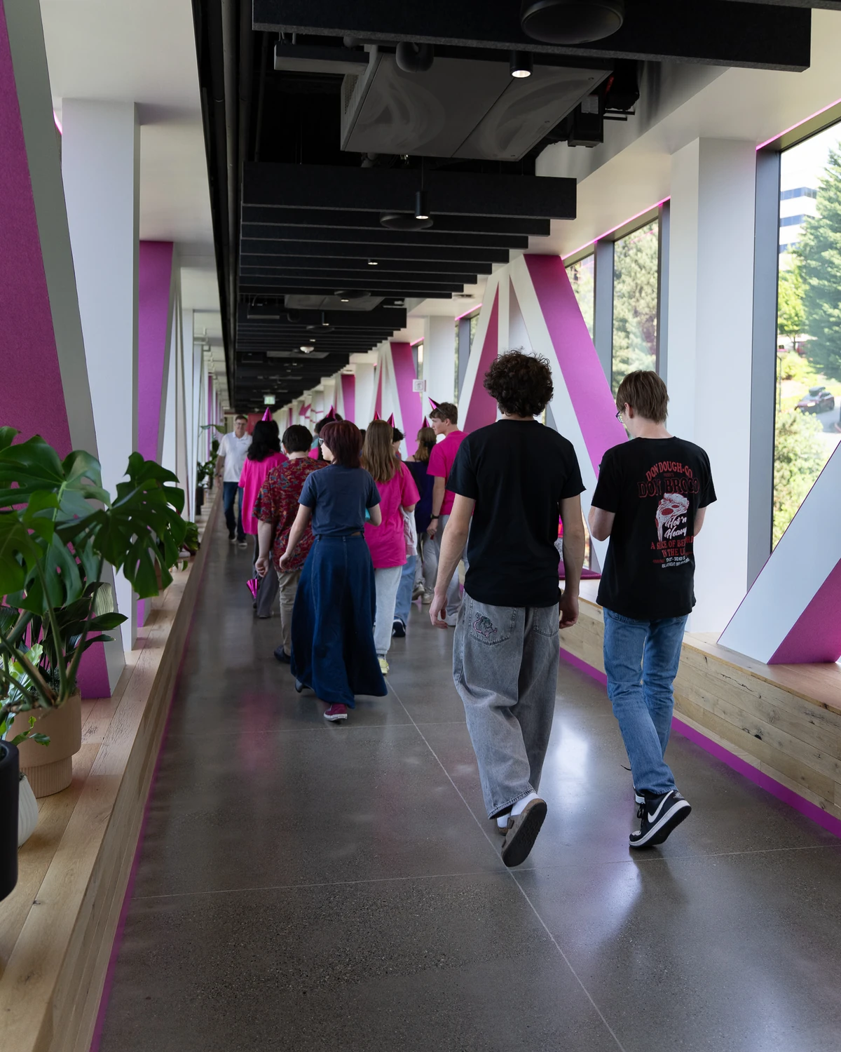 Students walk down a hallway at T-Mobile's headquarters